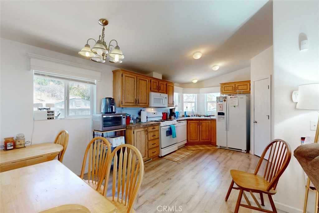 280 Canyon Creek Road Berry Creek, CA 95916 - Photo 10 of 36 a view of a dining room with furniture a chandelier and wooden floor