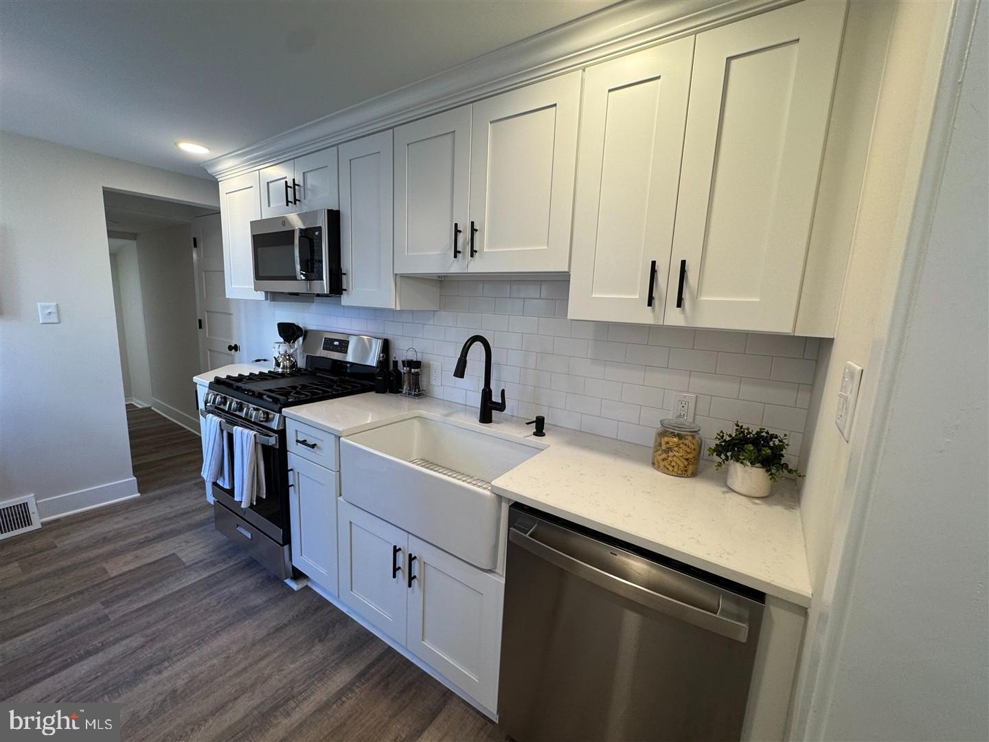66 East 3rd Street Moorestown, NJ 08057 - Photo 6 of 33 a kitchen with a sink cabinets and wooden floor