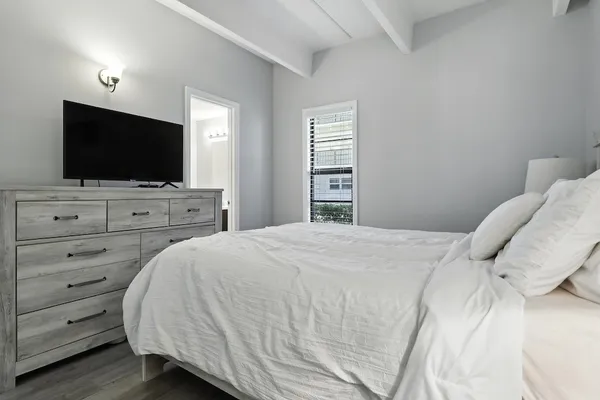 a bedroom with a bed and a flat screen tv