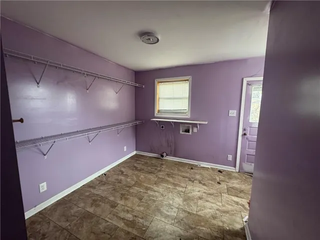 a view of a livingroom with an empty space and a window