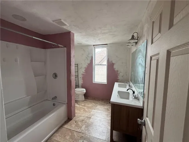 a bathroom with a bathtub and a shower