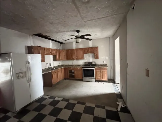 a kitchen with stainless steel appliances a refrigerator sink and cabinets