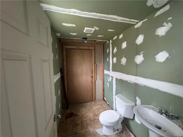 a bathroom with a toilet and a mirror
