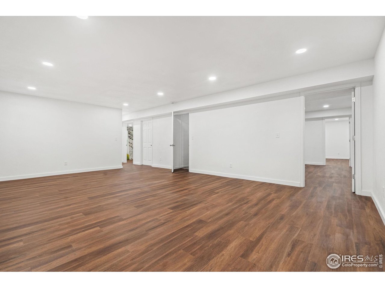 2239 Muir Lane Fort Collins, CO 80524 - Photo 18 of 31 a view of an empty room with wooden floor