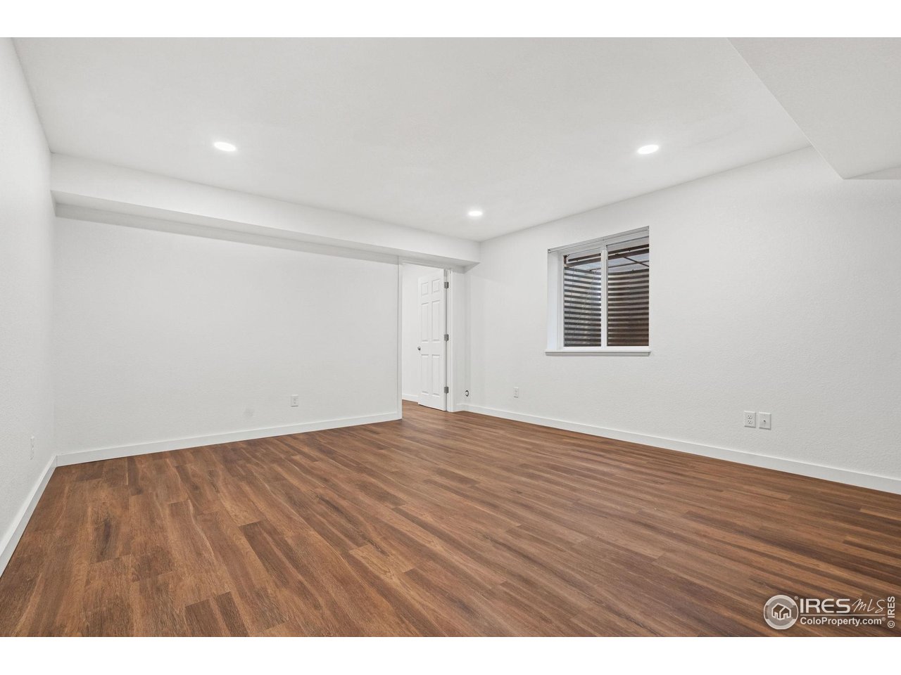 2239 Muir Lane Fort Collins, CO 80524 - Photo 20 of 31 a view of an empty room with wooden floor and a window
