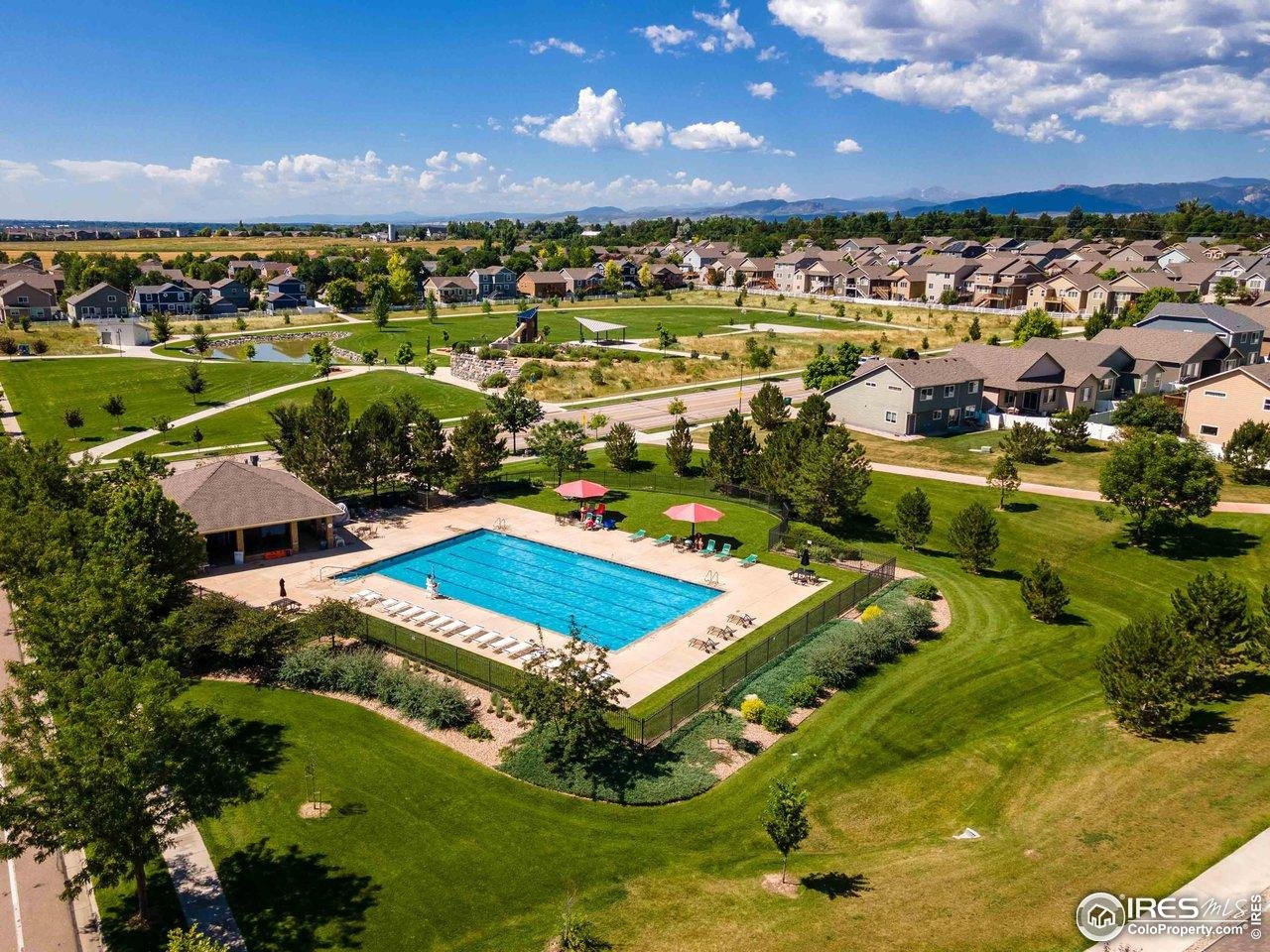 2239 Muir Lane Fort Collins, CO 80524 - Photo 31 of 31 a view of a swimming pool with outdoor seating and a lake view