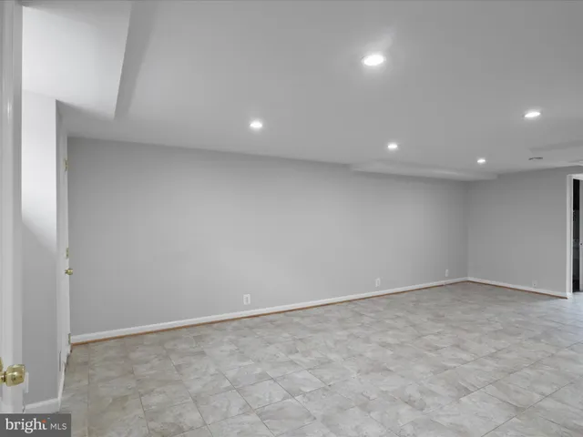 an empty room with white walls and entryway
