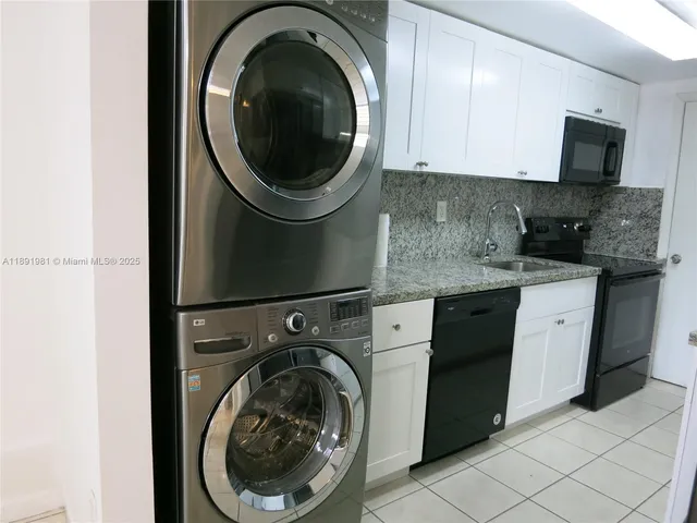 a utility room with sink dryer and washer