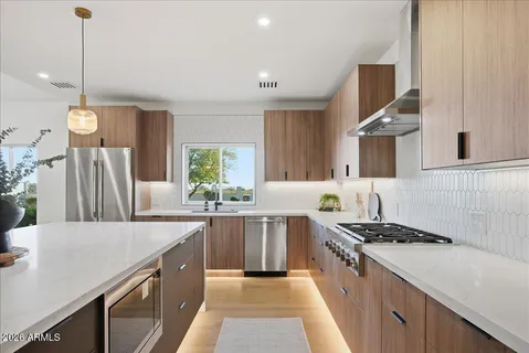 a kitchen with a sink stove and cabinets