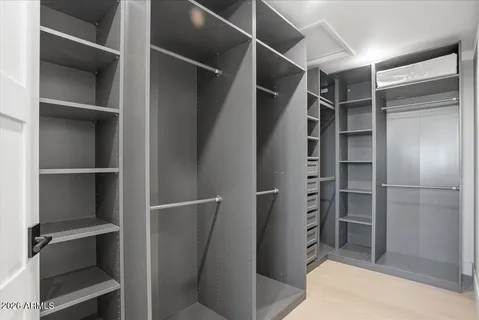 a view of walk in closet with empty racks