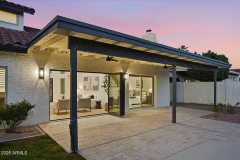 a swimming pool with outdoor seating and yard in back