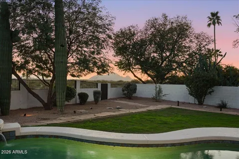 a view of a pathway with a wrought fence