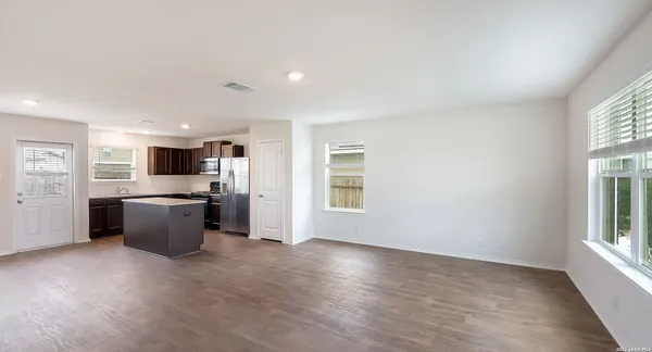 a large kitchen with a lot of counter top space and stainless steel appliances