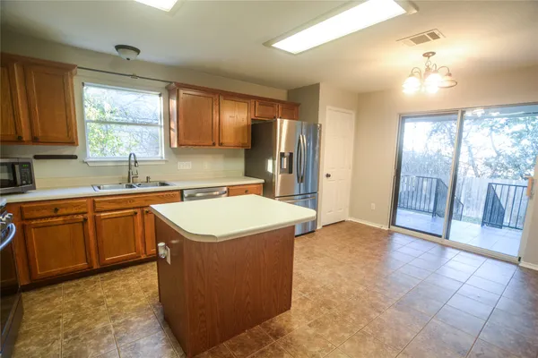 a view of a livingroom with furniture wooden floor chandelier and a chandelier