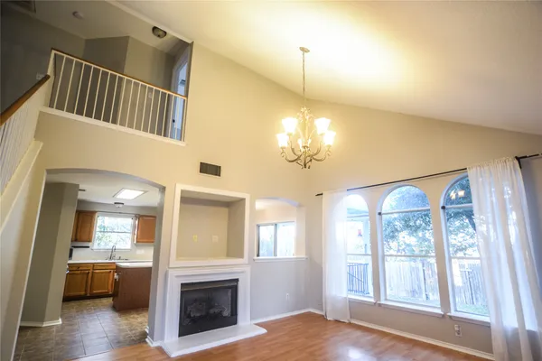 a view of a room with wooden floor and a ceiling fan