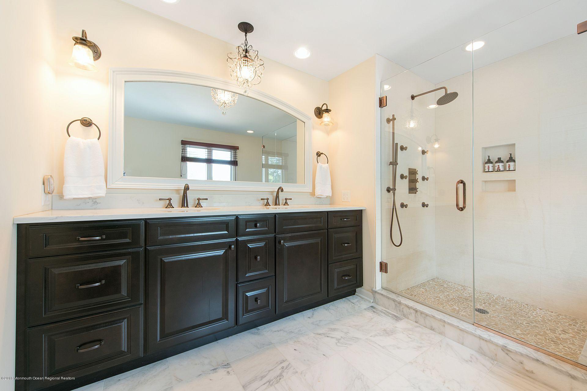 75 Seven Bridges Road Little Silver, NJ 07739 - Photo 12 of 43 a bathroom with a sink vanity and a mirror