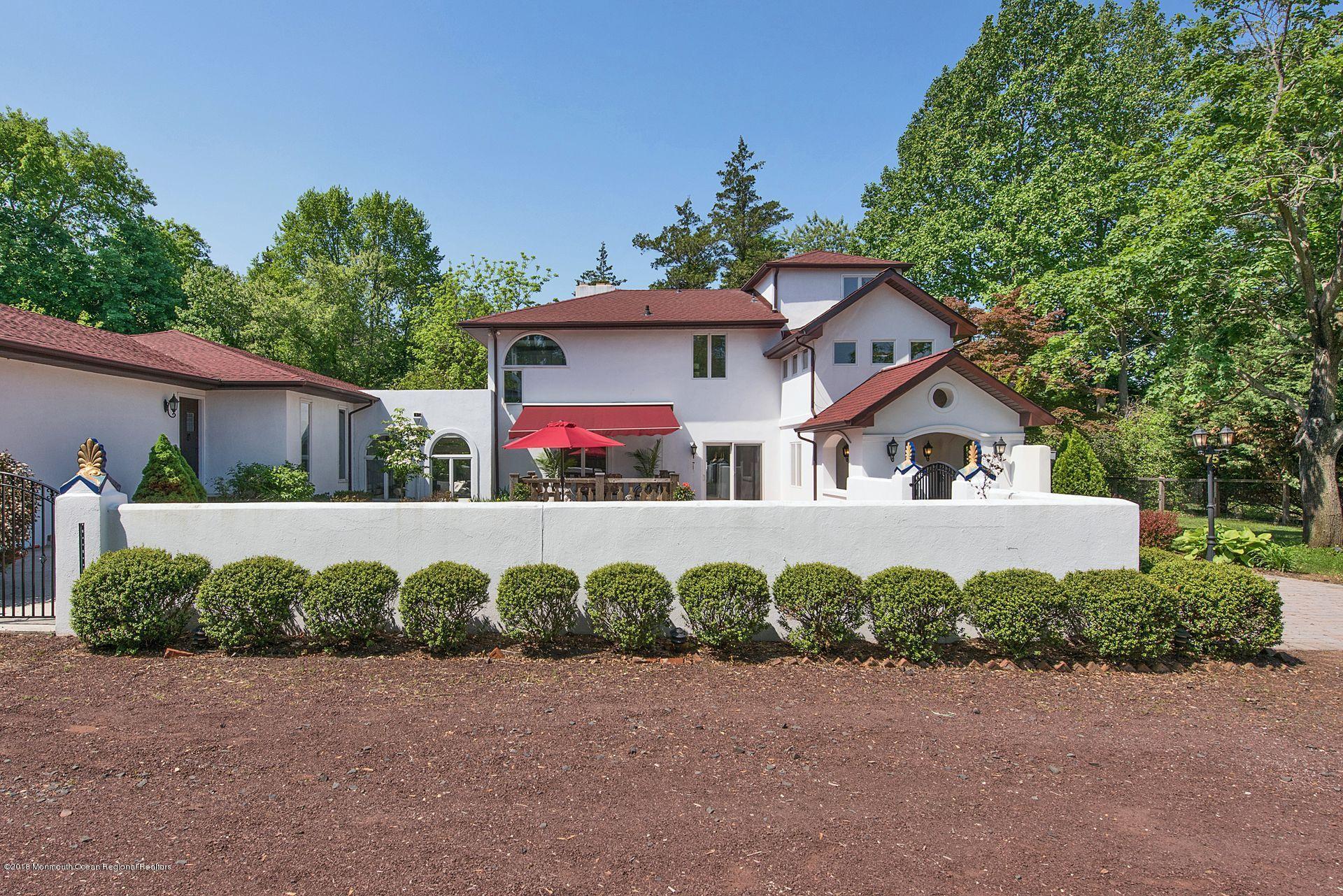 75 Seven Bridges Road Little Silver, NJ 07739 - Photo 16 of 43 a front view of a house with a yard and garage