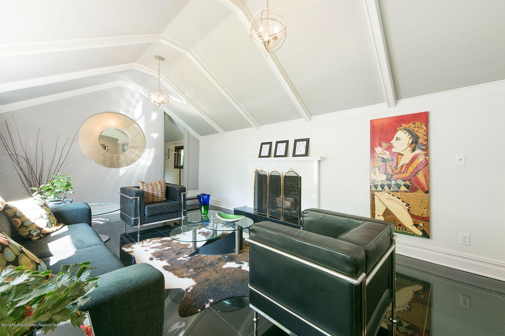 75 Seven Bridges Road Little Silver, NJ 07739 - Photo 22 of 43 a living room with furniture and a clock