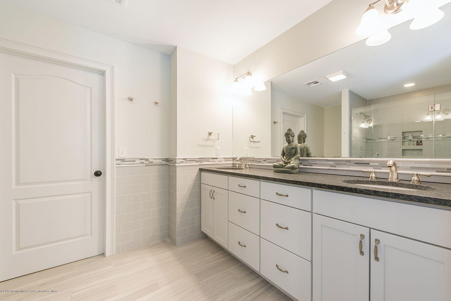 75 Seven Bridges Road Little Silver, NJ 07739 - Photo 28 of 43 a bathroom with double sink and a mirror