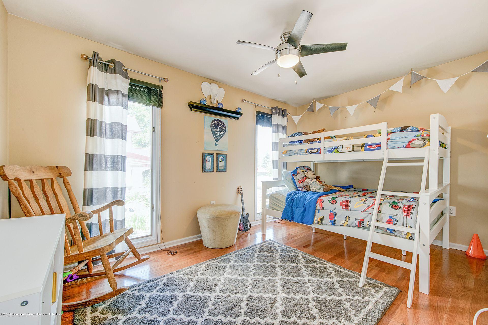 75 Seven Bridges Road Little Silver, NJ 07739 - Photo 31 of 43 a bedroom with a bed and a chandelier