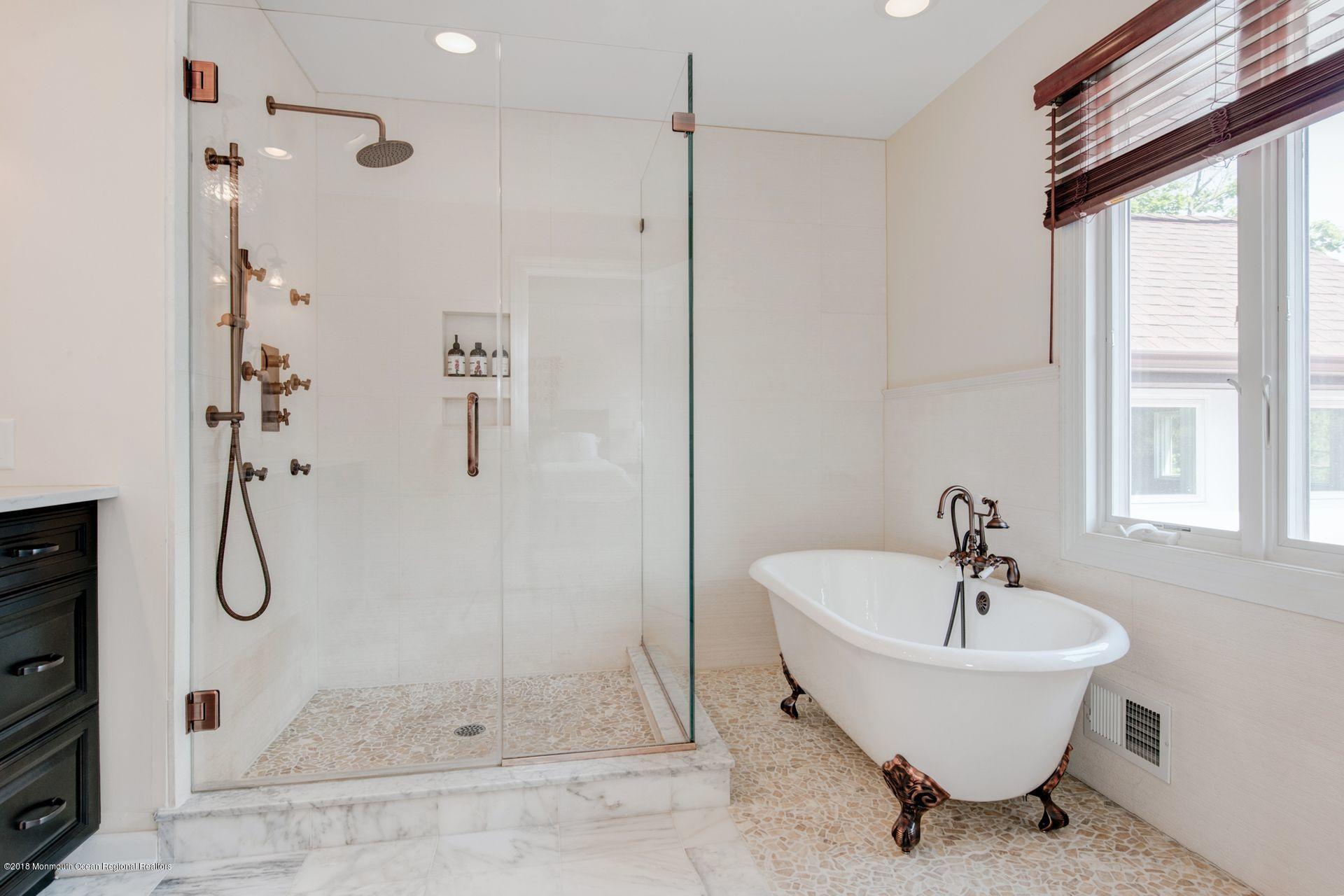 75 Seven Bridges Road Little Silver, NJ 07739 - Photo 32 of 43 a bathroom with a bathtub and shower