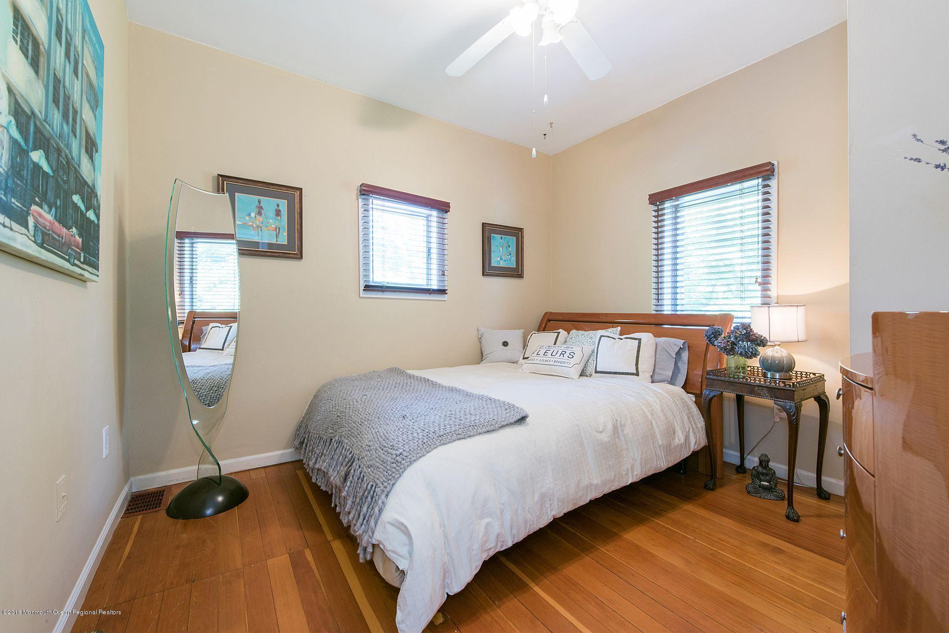 75 Seven Bridges Road Little Silver, NJ 07739 - Photo 33 of 43 a bedroom with a bed and wooden floor