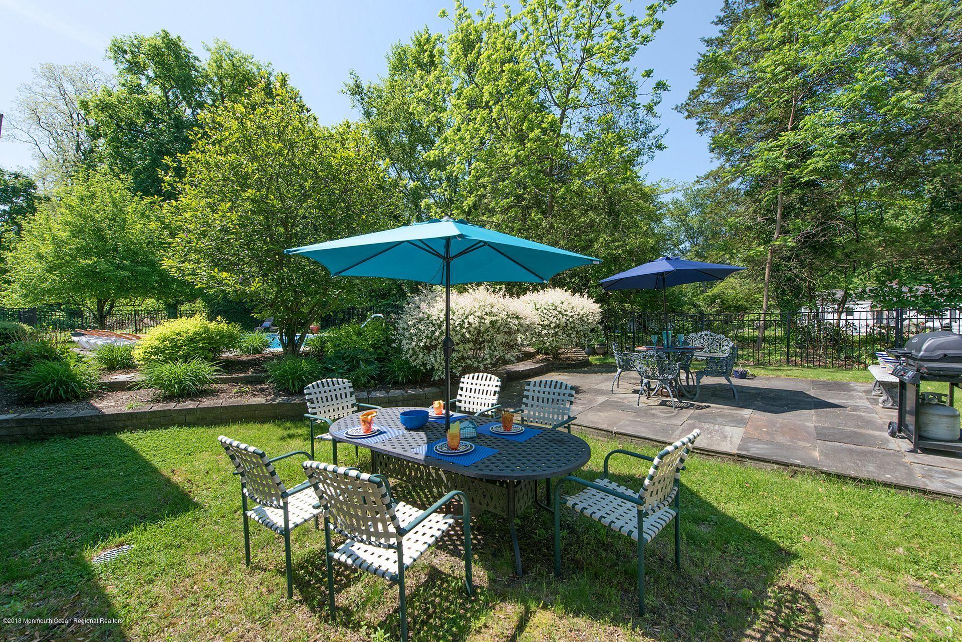 75 Seven Bridges Road Little Silver, NJ 07739 - Photo 37 of 43 a view of backyard with outdoor seating and trees