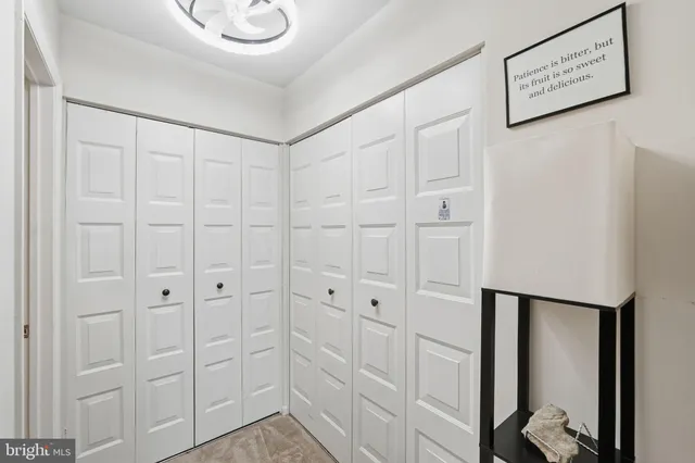 a bathroom with a sink vanity mirror and painting on the wall