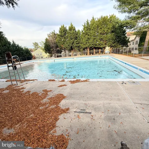 a front view of a house with garden and trees