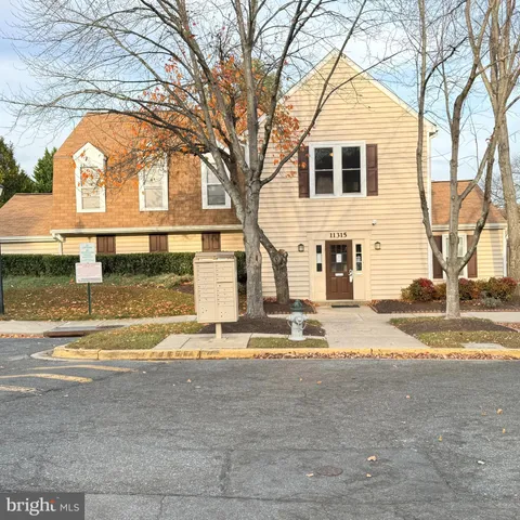 a view of a house with a backyard and a table and chairs