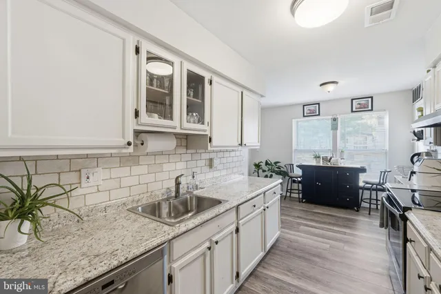 a kitchen with a sink and cabinets