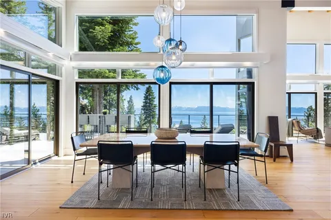 a dining room with furniture a chandelier and wooden floor