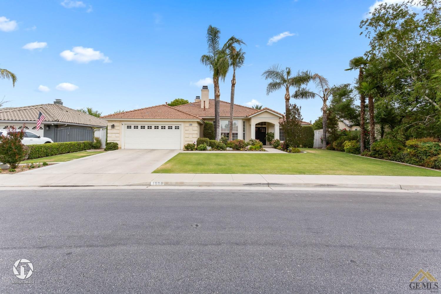 Undisclosed Address Bakersfield, CA 93311 - Photo 1 of 51 a front view of a house with a yard and potted plants