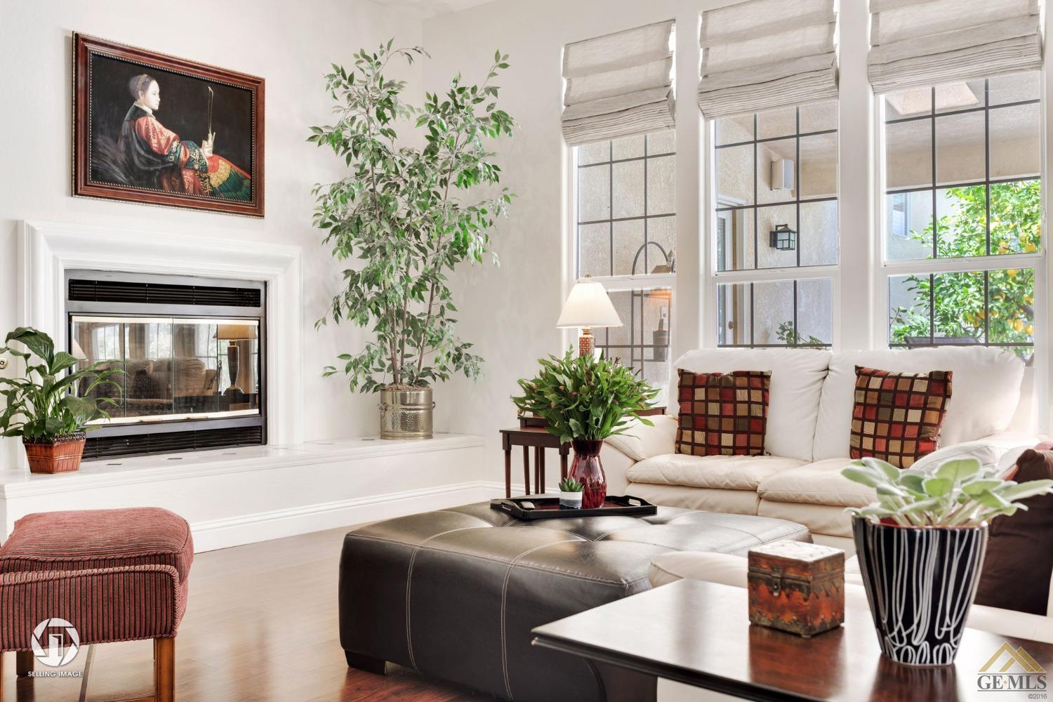Undisclosed Address Bakersfield, CA 93311 - Photo 15 of 51 a living room with furniture potted plant and a fireplace