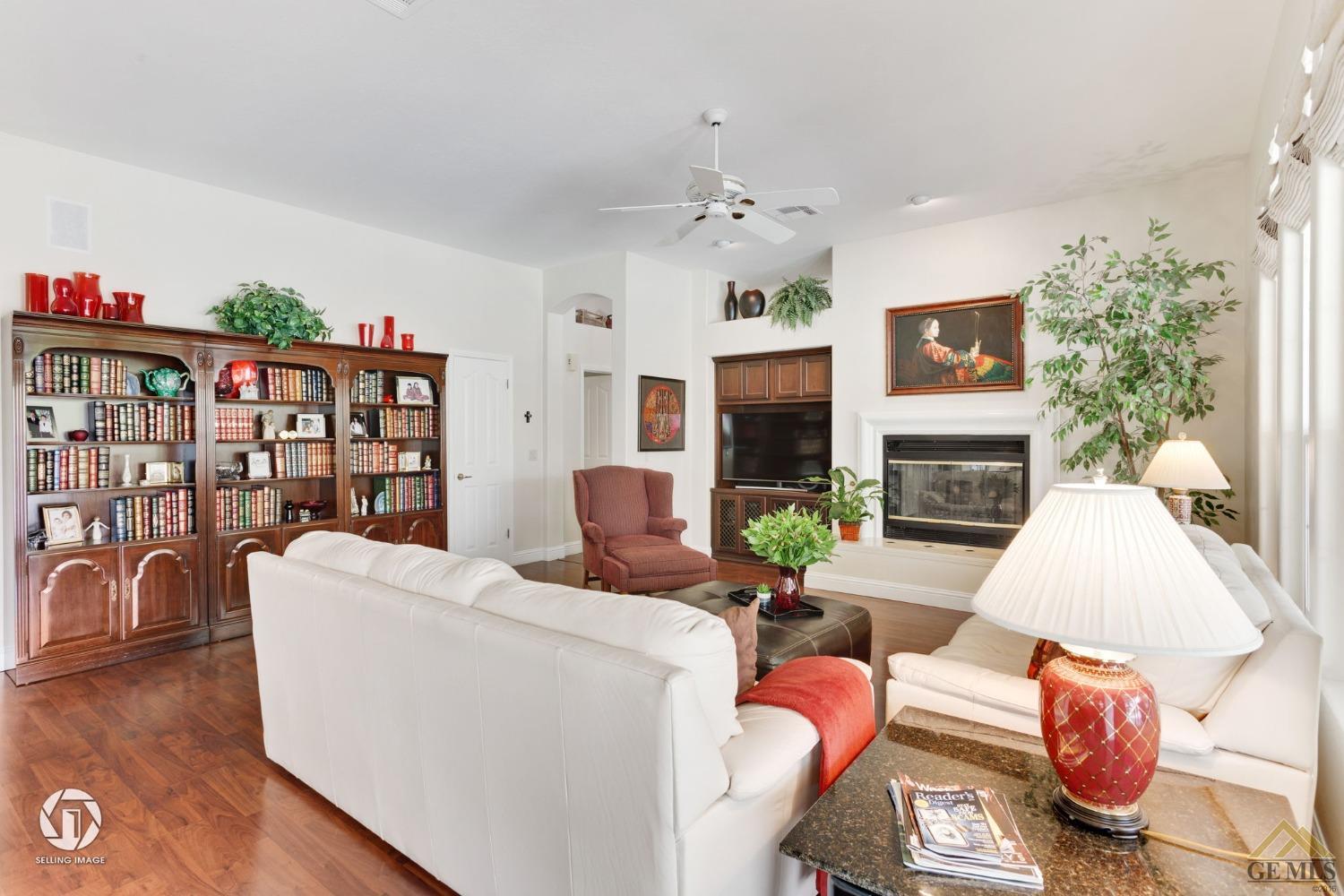 Undisclosed Address Bakersfield, CA 93311 - Photo 16 of 51 a living room with furniture a fireplace and a flat screen tv