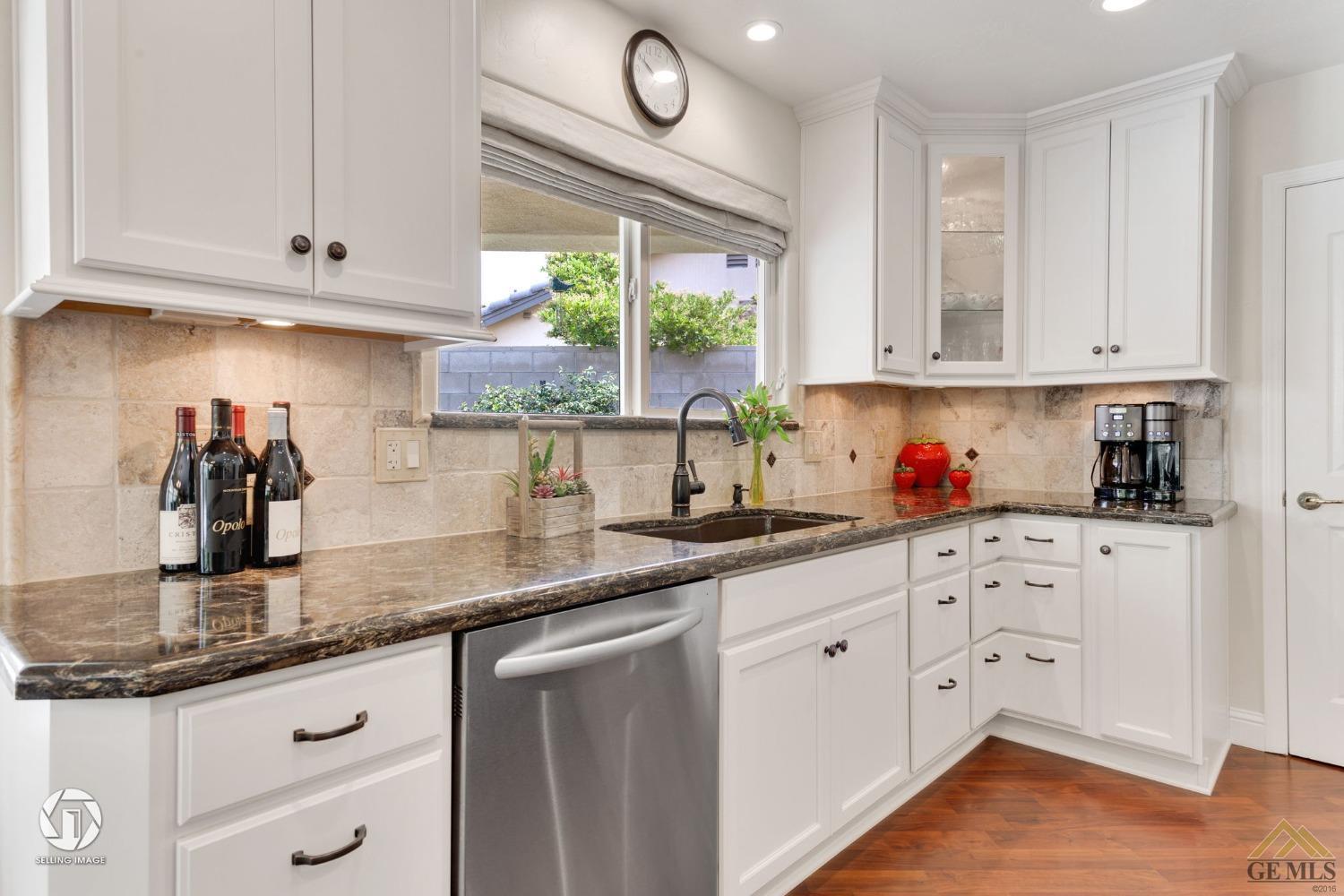 Undisclosed Address Bakersfield, CA 93311 - Photo 21 of 51 a kitchen with granite countertop white cabinets white appliances and a window