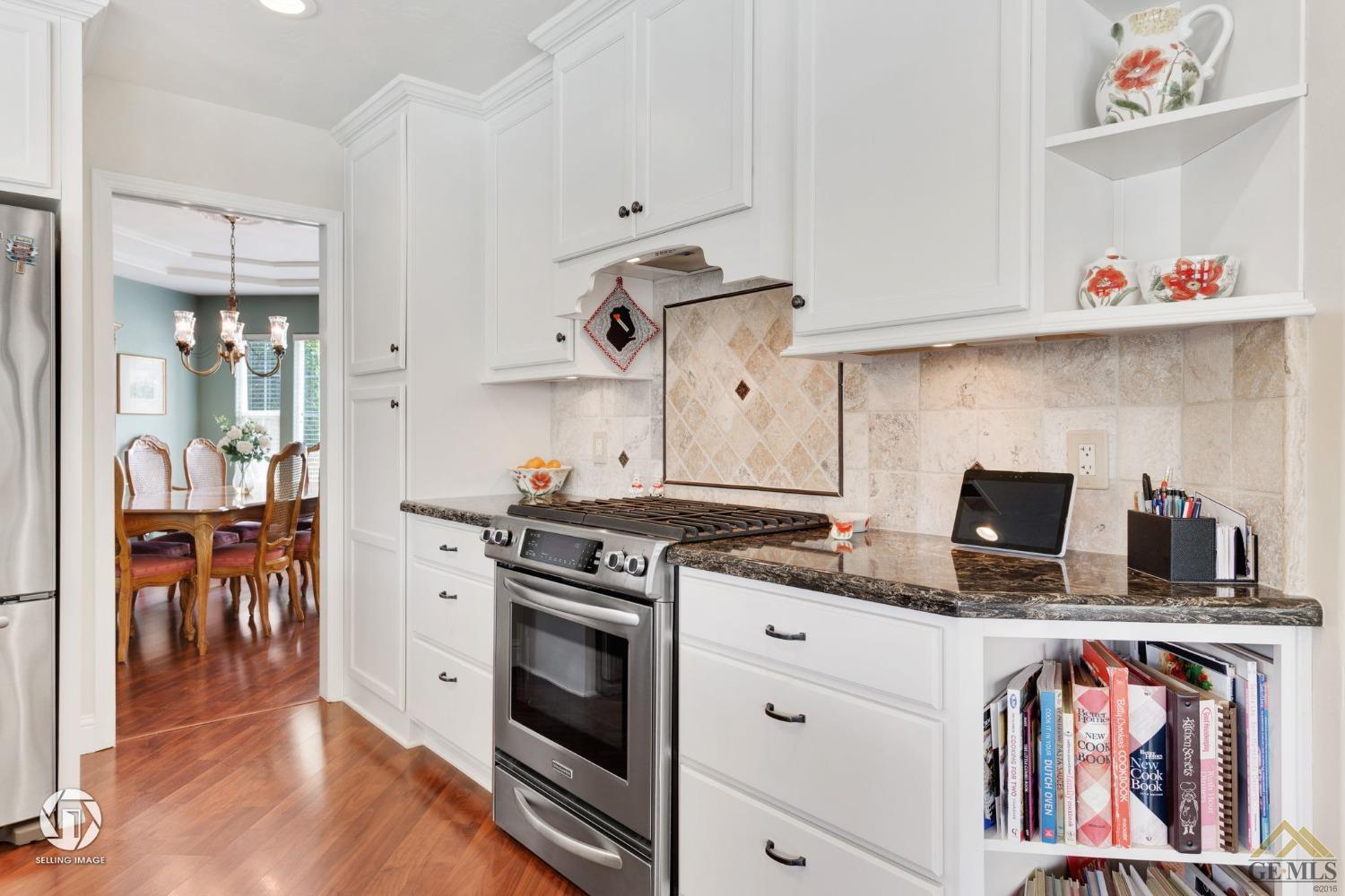 Undisclosed Address Bakersfield, CA 93311 - Photo 22 of 51 a kitchen with stainless steel appliances granite countertop a stove and a sink