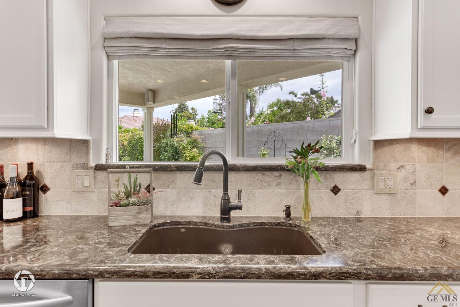 Undisclosed Address Bakersfield, CA 93311 - Photo 24 of 51 a kitchen with granite countertop a sink and a window