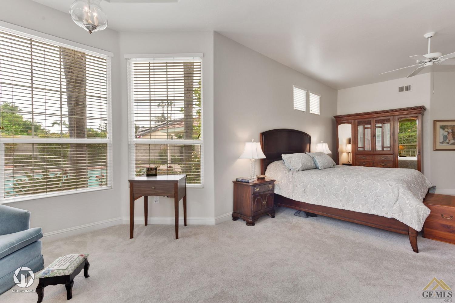 Undisclosed Address Bakersfield, CA 93311 - Photo 30 of 51 a bedroom with a large bed and windows