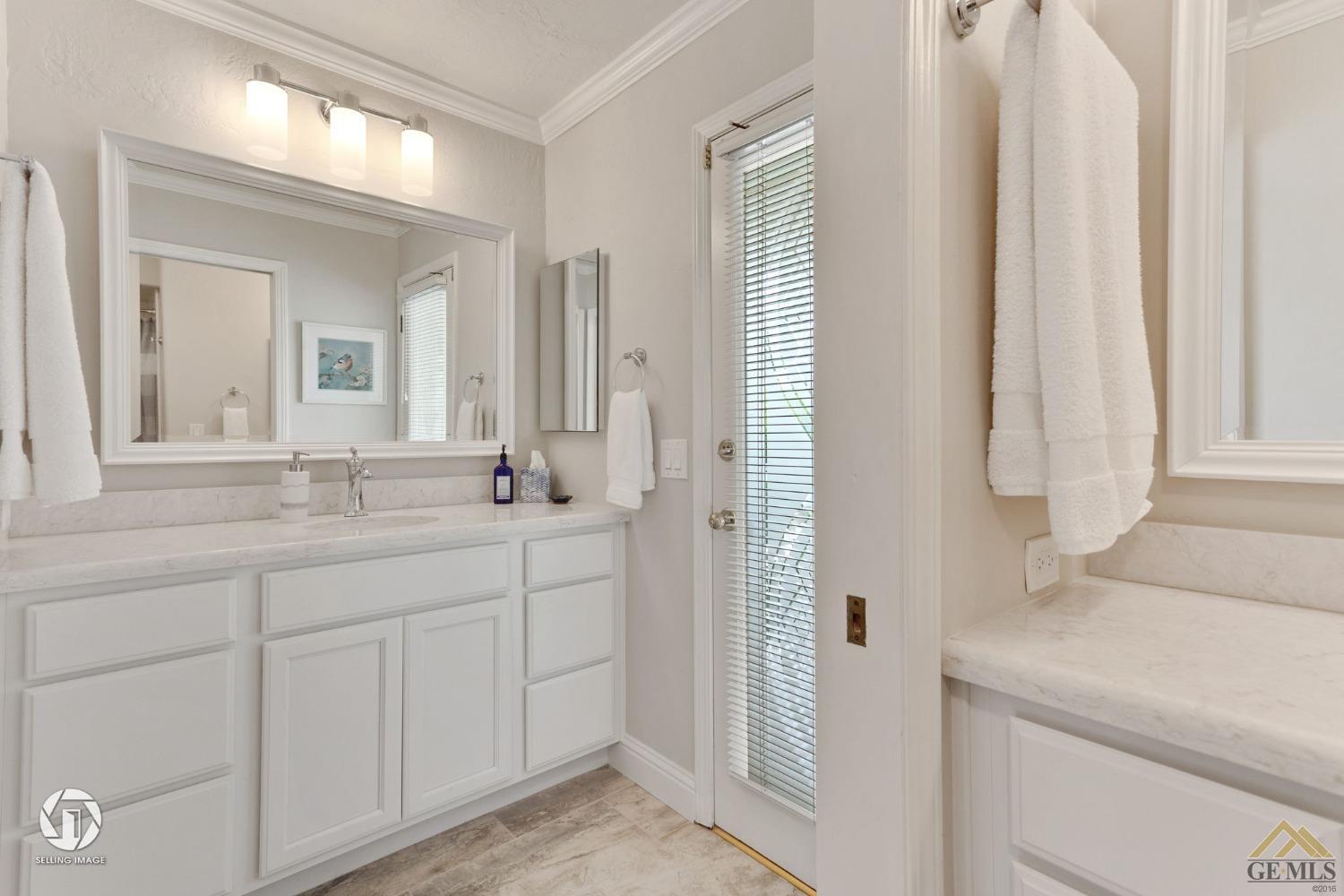 Undisclosed Address Bakersfield, CA 93311 - Photo 38 of 51 a bathroom with a double vanity sink and a mirror