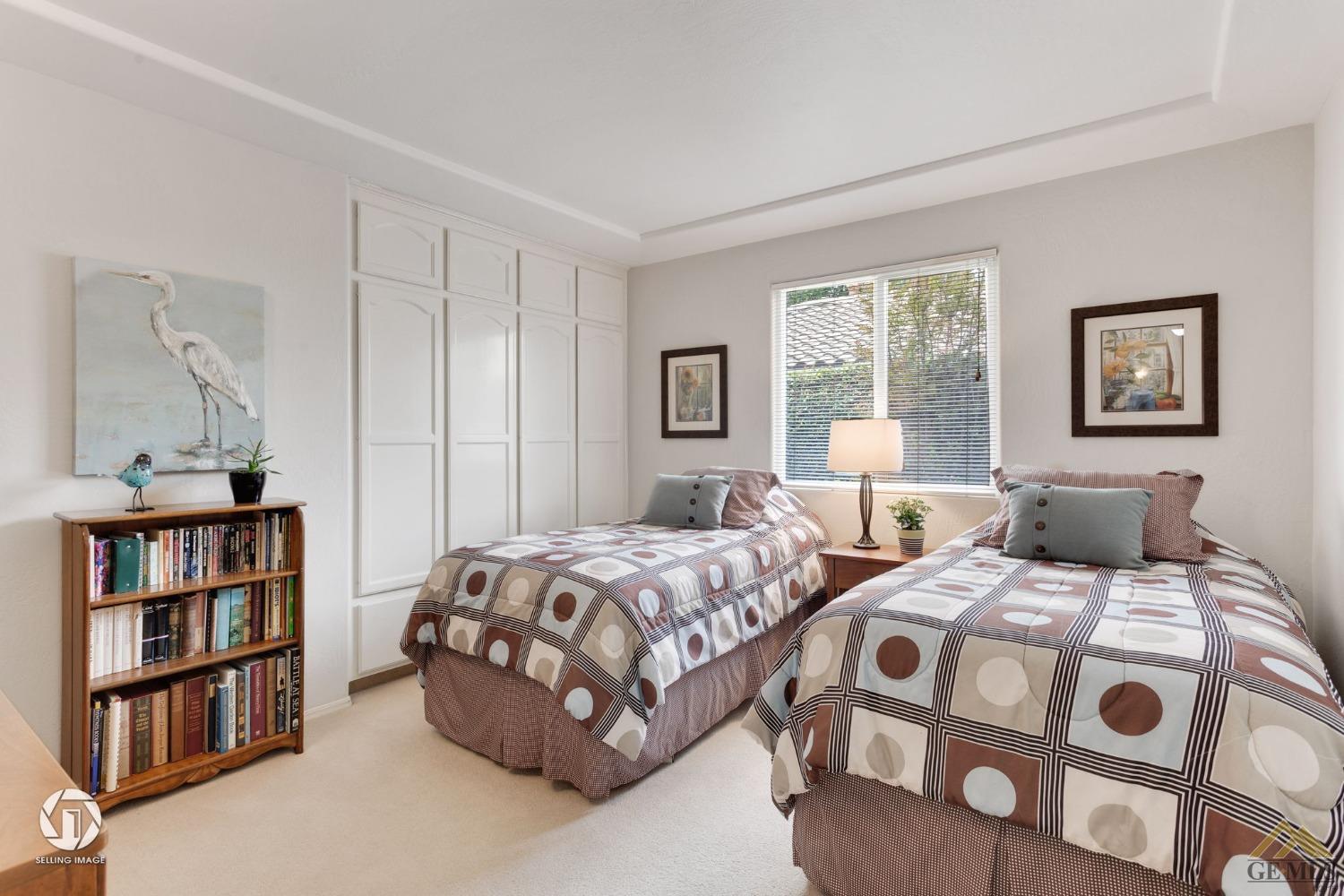 Undisclosed Address Bakersfield, CA 93311 - Photo 41 of 51 a bedroom with two beds and a book shelf