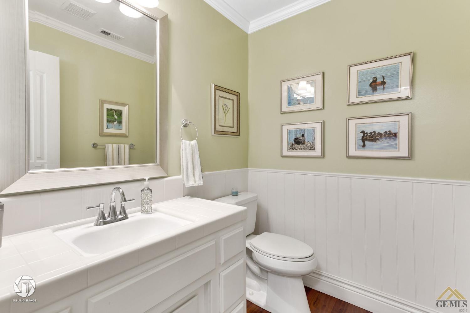 Undisclosed Address Bakersfield, CA 93311 - Photo 43 of 51 a bathroom with a toilet a sink and mirror