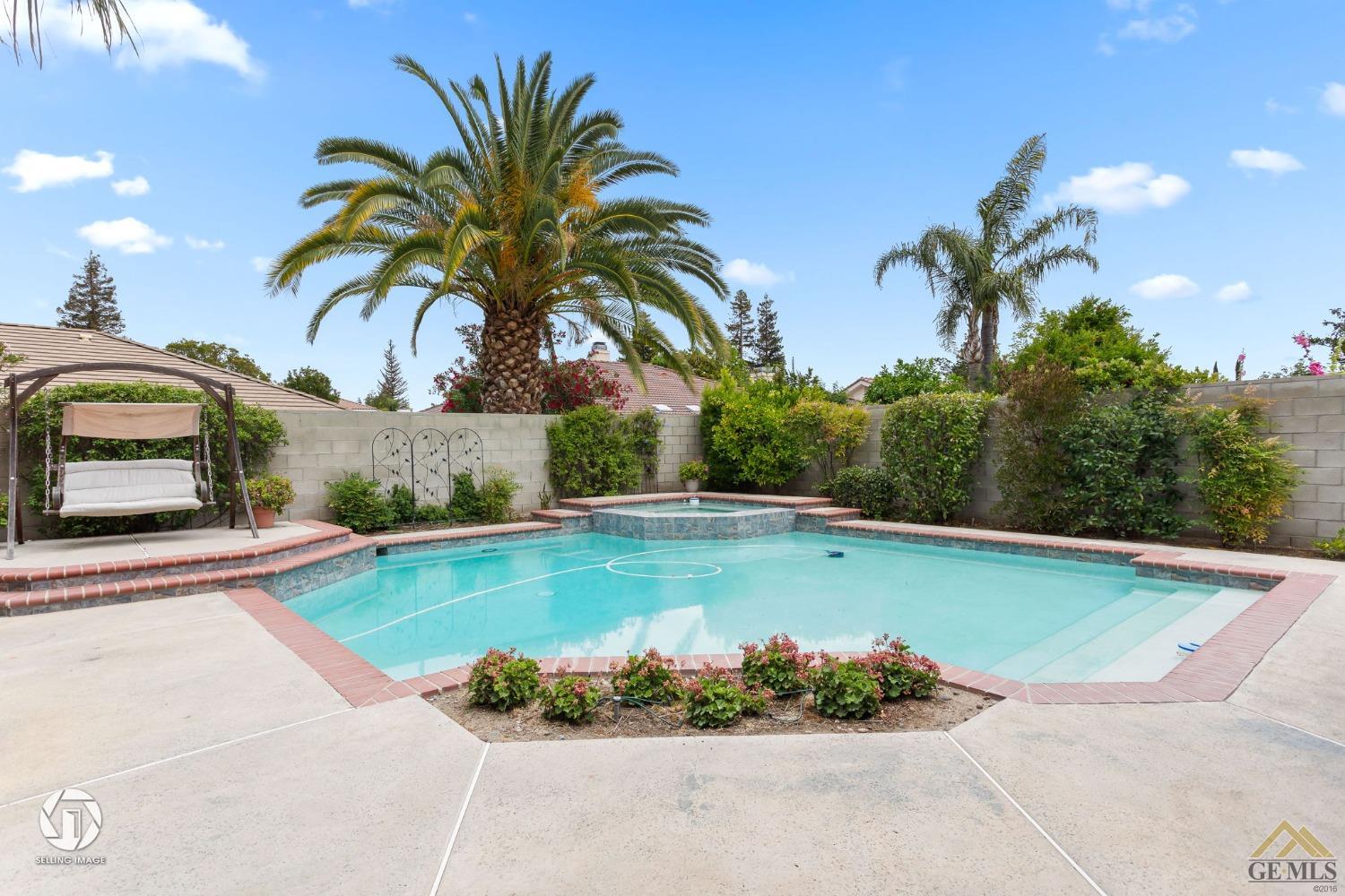 Undisclosed Address Bakersfield, CA 93311 - Photo 46 of 51 a view of a swimming pool with a lounge chair and grass