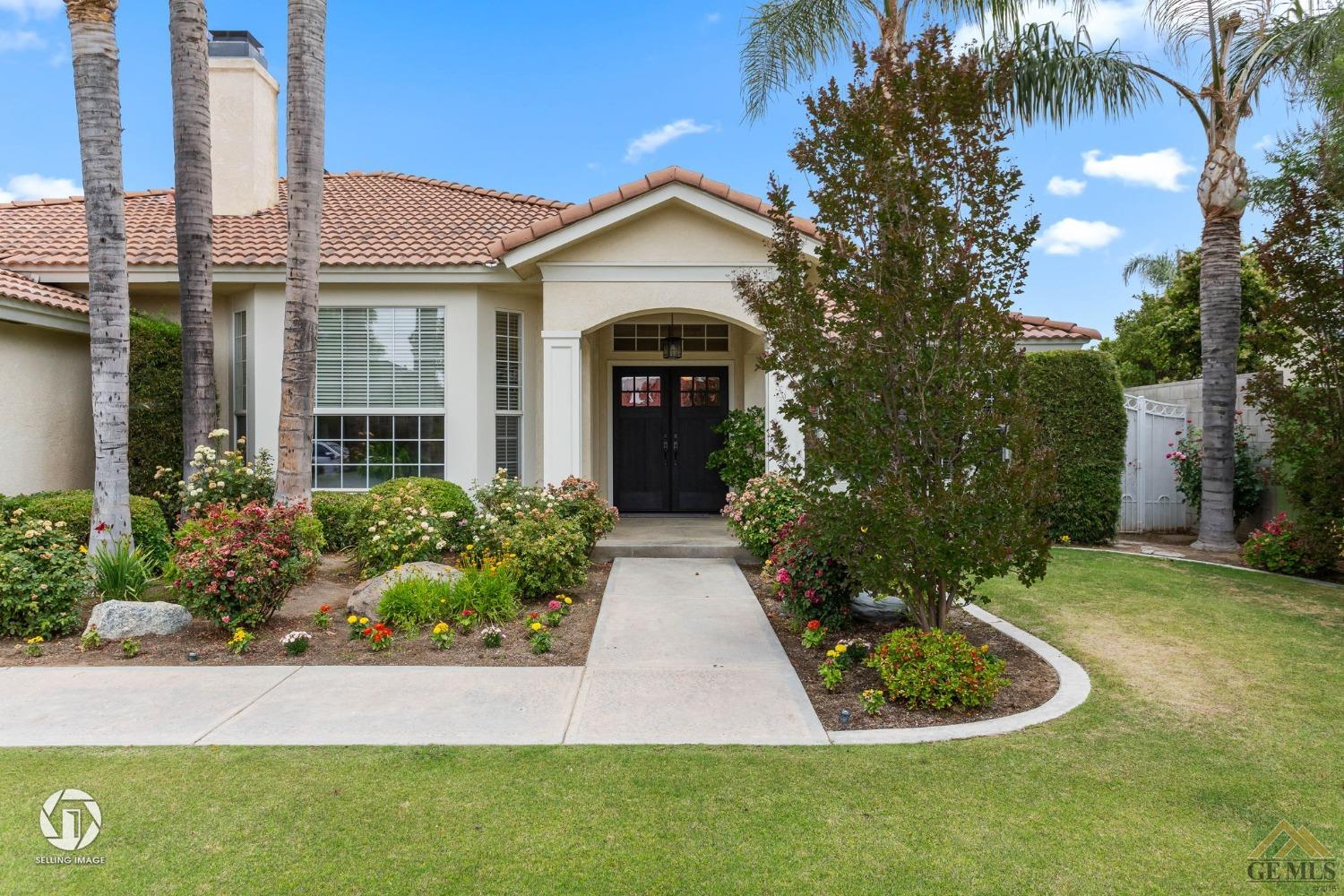Undisclosed Address Bakersfield, CA 93311 - Photo 5 of 51 a front view of a house with garden and trees