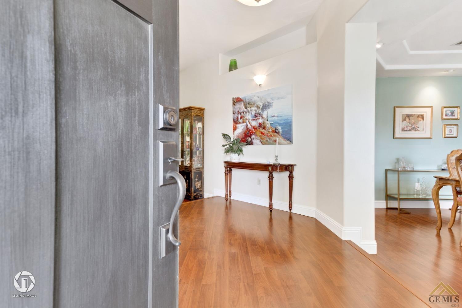Undisclosed Address Bakersfield, CA 93311 - Photo 6 of 51 a view of a hallway with wooden floor and furniture