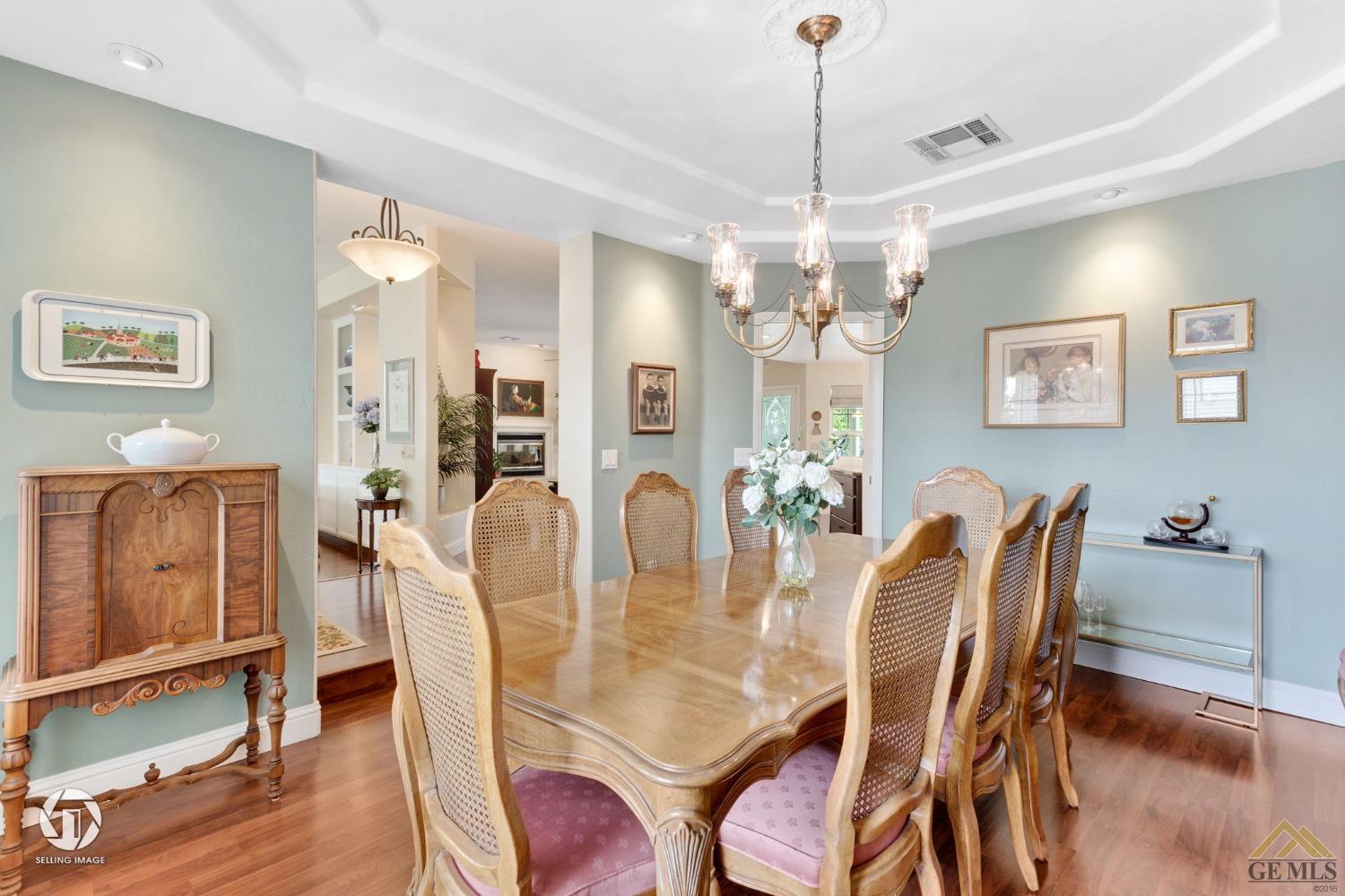 Undisclosed Address Bakersfield, CA 93311 - Photo 10 of 51 a dining room with furniture a chandelier and wooden floor