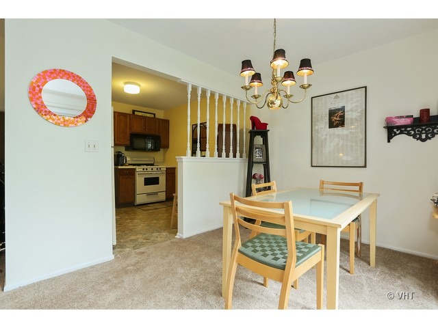 1549 Sandhurst Court, Unit B Wheaton, IL 60189 - Photo 5 of 11 a view of an dining room and chandelier