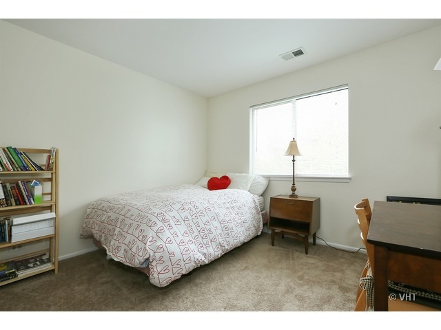 1549 Sandhurst Court, Unit B Wheaton, IL 60189 - Photo 6 of 11 a living room with furniture and a window