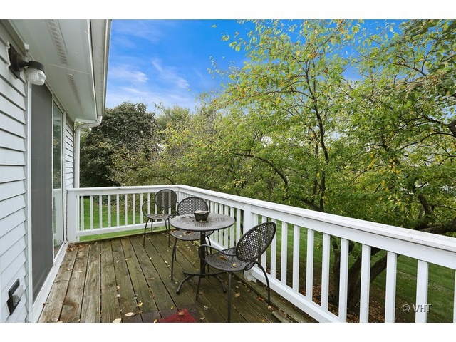 1549 Sandhurst Court, Unit B Wheaton, IL 60189 - Photo 10 of 11 a view of balcony with wooden floor and fence