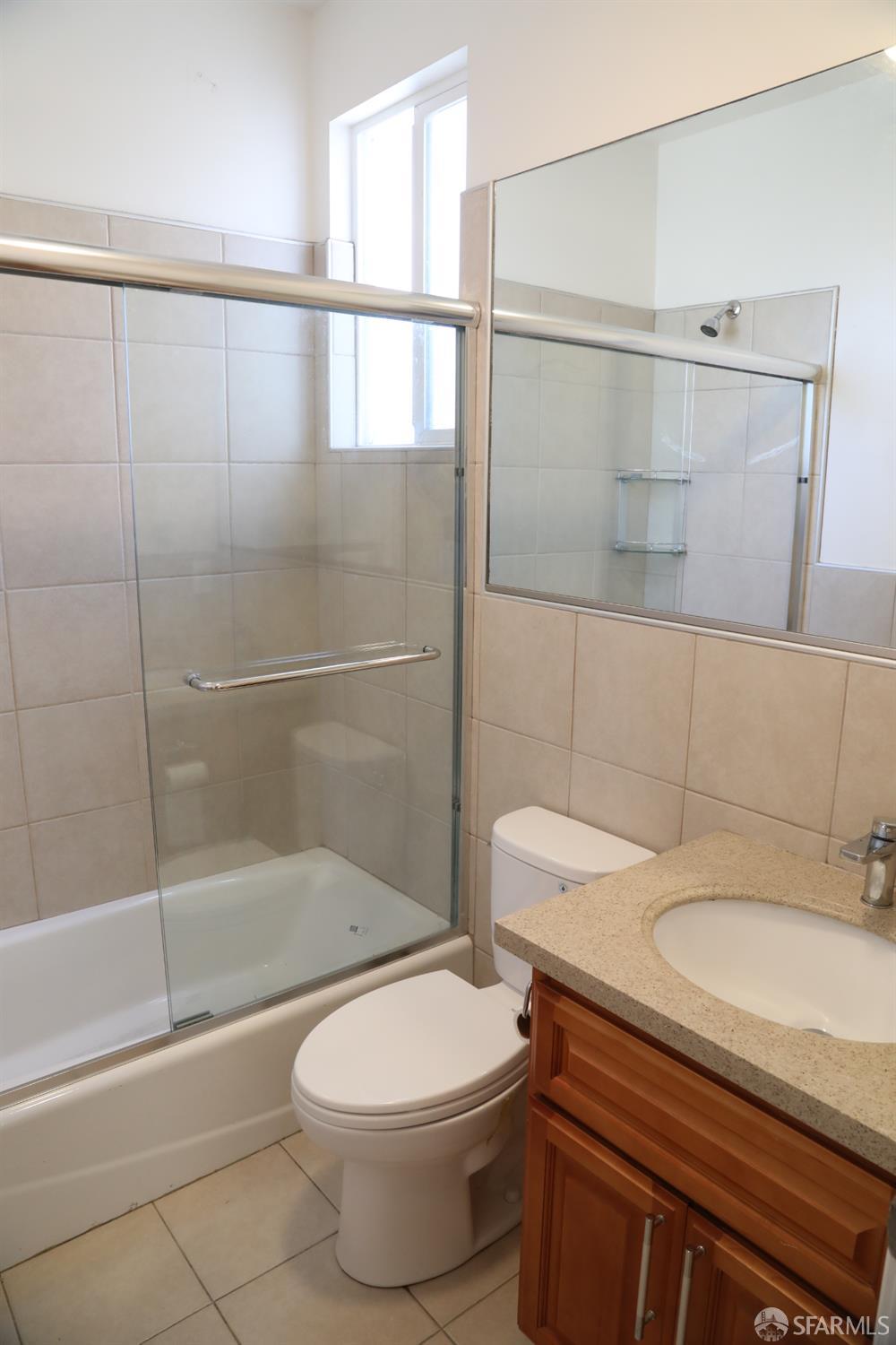 2726 San Bruno Avenue, Unit 2724 San Francisco, CA 94134 - Photo 11 of 13 a bathroom with a sink a toilet and shower